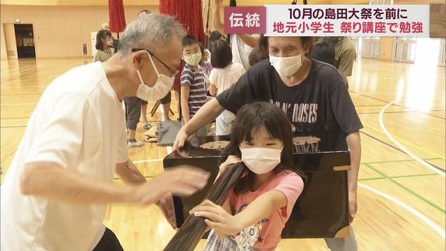 画像: 「重い！」「歩けそうにない…」　「帯まつり」の出前講座で小学生が悪戦苦闘　静岡・島田市 youtu.be